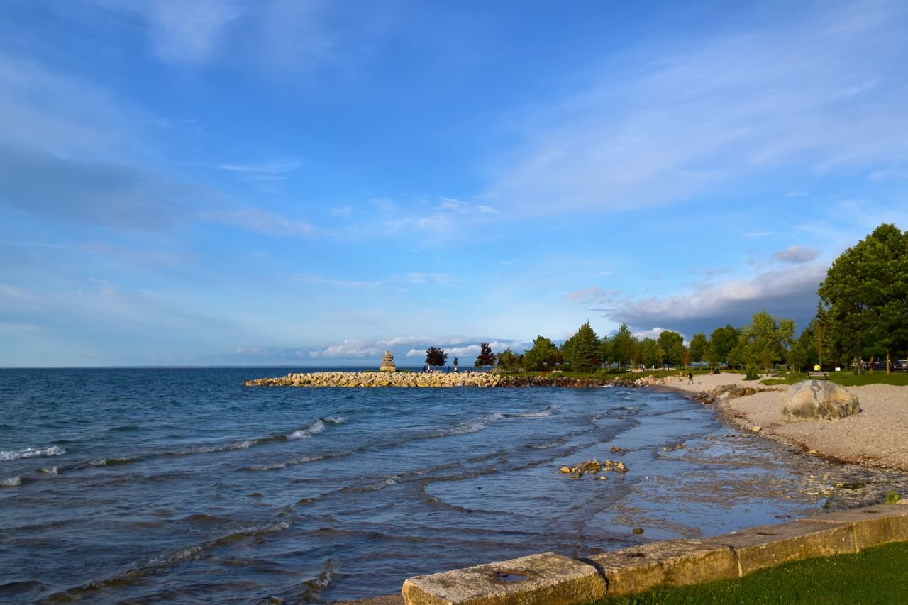 Services Beautiful coastline view in Collingwood, Ontario with clear blue skies and gentle waves.
